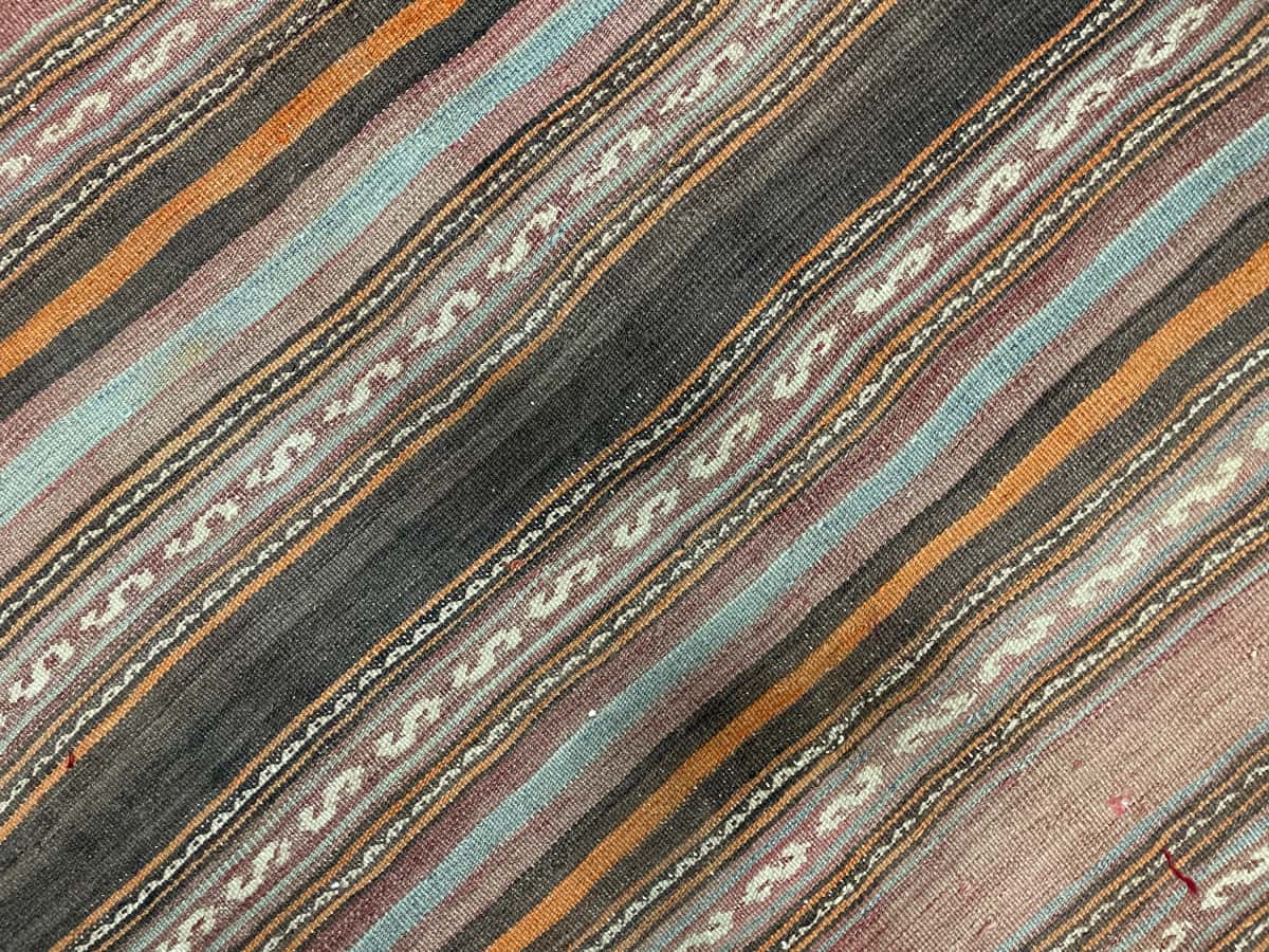Persian rug of Sumak style in dimensions 163 centimeters length by 138 centimeters width with mainly brown colors — Texture close-up