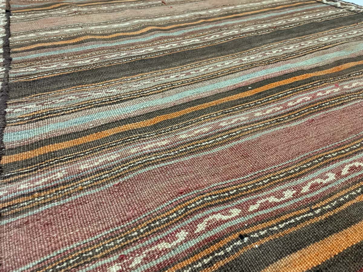 Persian rug of Sumak style in dimensions 163 centimeters length by 138 centimeters width with mainly brown colors — Texture close-up