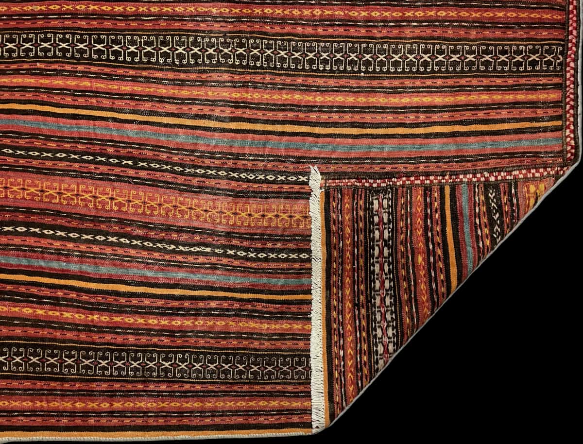 Persian rug of Sumak style in dimensions 206 centimeters length by 151 centimeters width with mainly red and orange colors — Folded