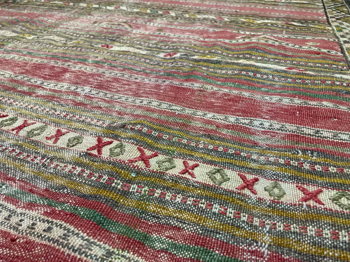 Persian rug of Sumak style in dimensions 216 centimeters length by 150 centimeters width with mainly red and yellow colors — Texture close-up