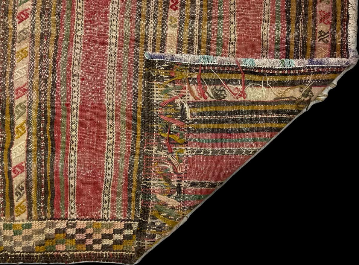 Persian rug of Sumak style in dimensions 216 centimeters length by 150 centimeters width with mainly red and yellow colors — Folded