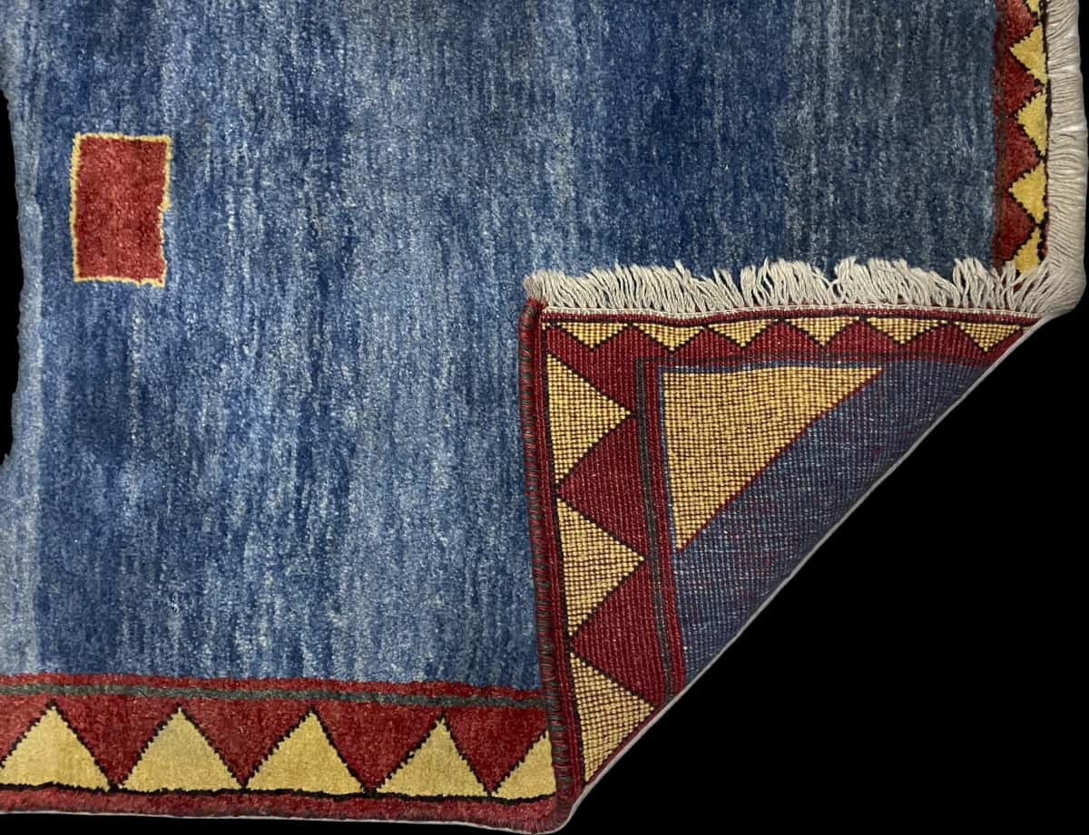 Persian rug of Gabbeh style in dimensions 200 centimeters length by 128 centimeters width with mainly blue colors — Folded