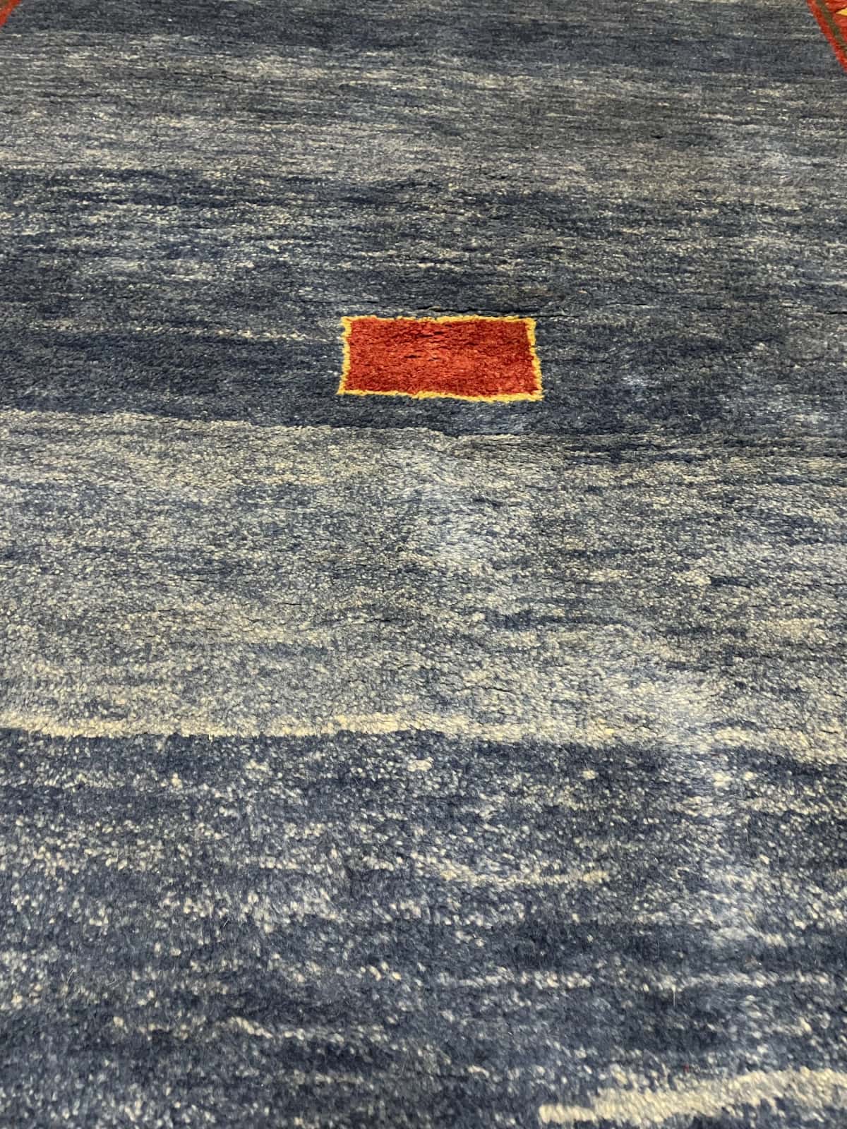 Persian rug of Gabbeh style in dimensions 200 centimeters length by 128 centimeters width with mainly blue colors — Texture close-up
