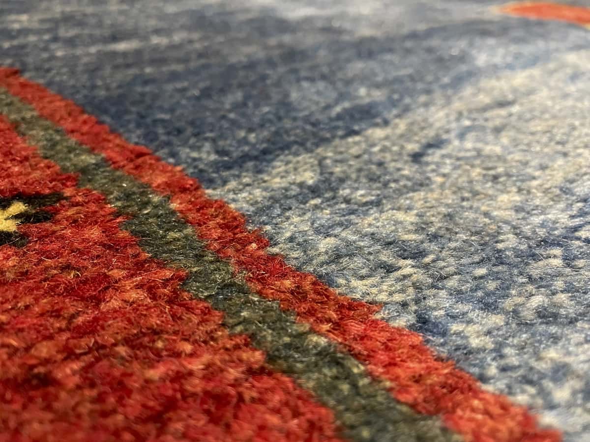 Persian rug of Gabbeh style in dimensions 200 centimeters length by 128 centimeters width with mainly blue colors — Texture close-up