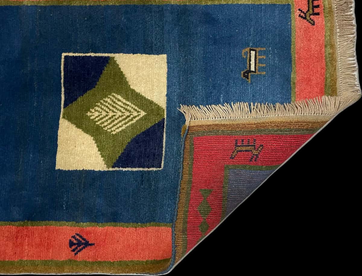Persian rug of Gabbeh style in dimensions 150 centimeters length by 102 centimeters width with mainly green colors — Folded