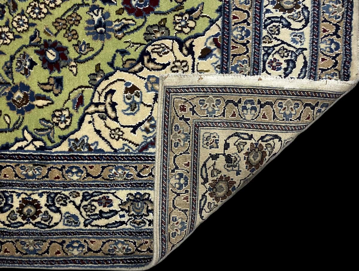 Persian rug of Nain style in dimensions 208 centimeters length by 146 centimeters width with mainly green and blue colors — Folded