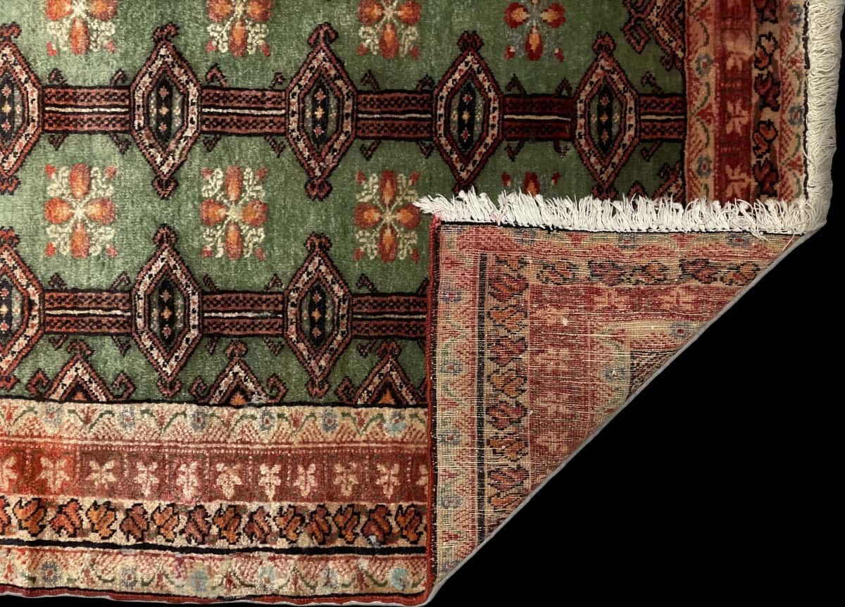Persian rug of Turkoman style in dimensions 179 centimeters length by 94 centimeters width with mainly green and red colors — Folded