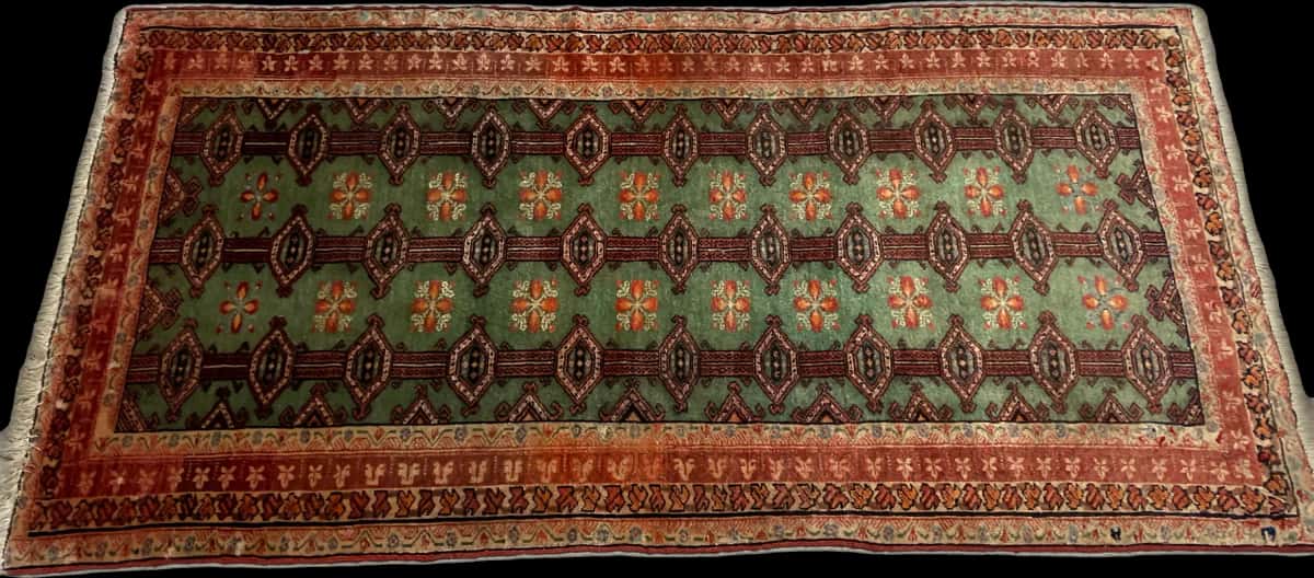 persischer Teppich im turkmenischer Stil in den Maßen 179 Zentimeter Länge mal 94 Zentimeter Breite mit überwiegend grün und rot Farben — Perspektive