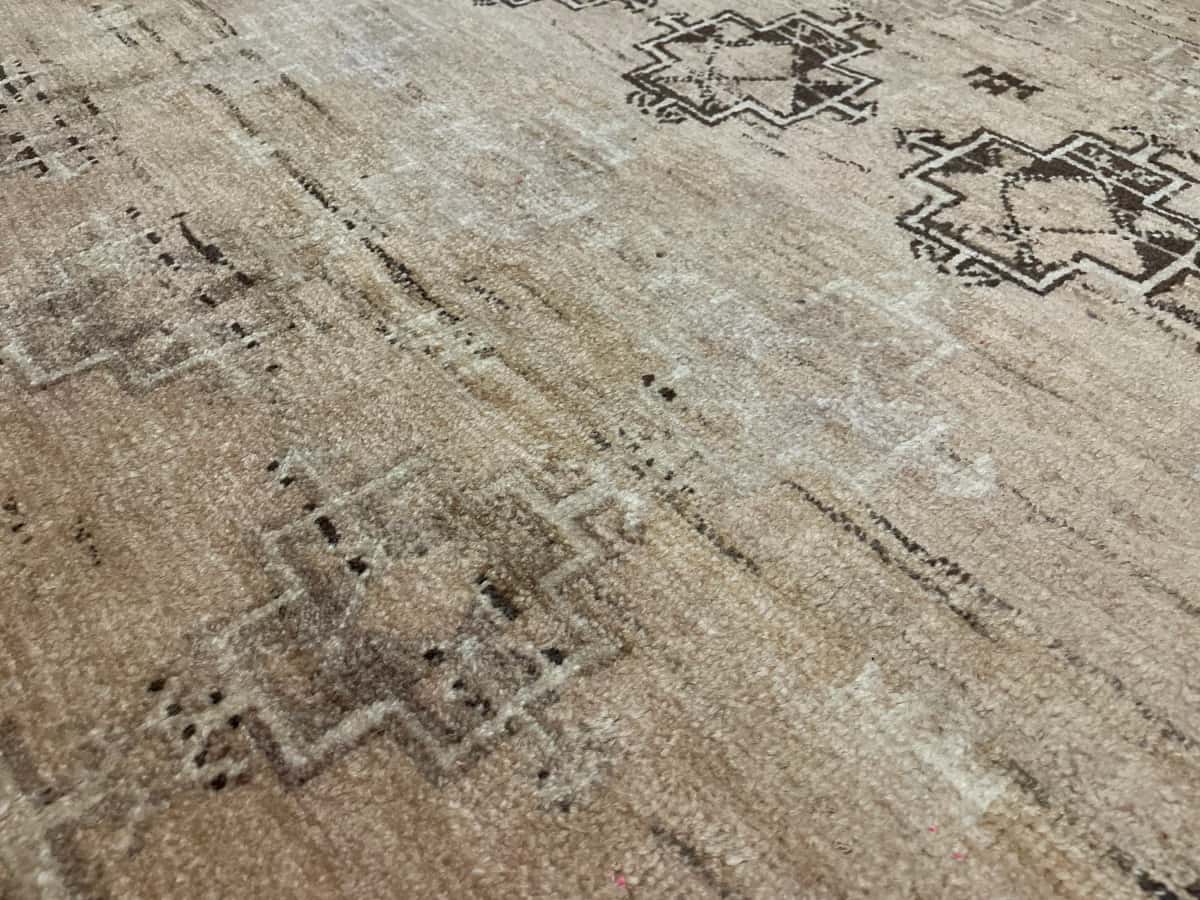 Persian rug of Baluch style in dimensions 220 centimeters length by 117 centimeters width with mainly brown colors — Texture close-up