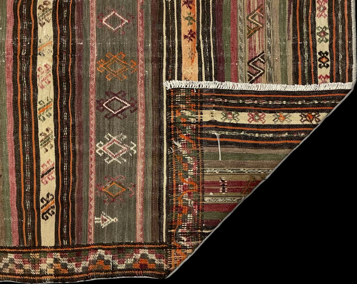 Persian rug of Sumak style in dimensions 212 centimeters length by 146 centimeters width with mainly red and green colors — Folded