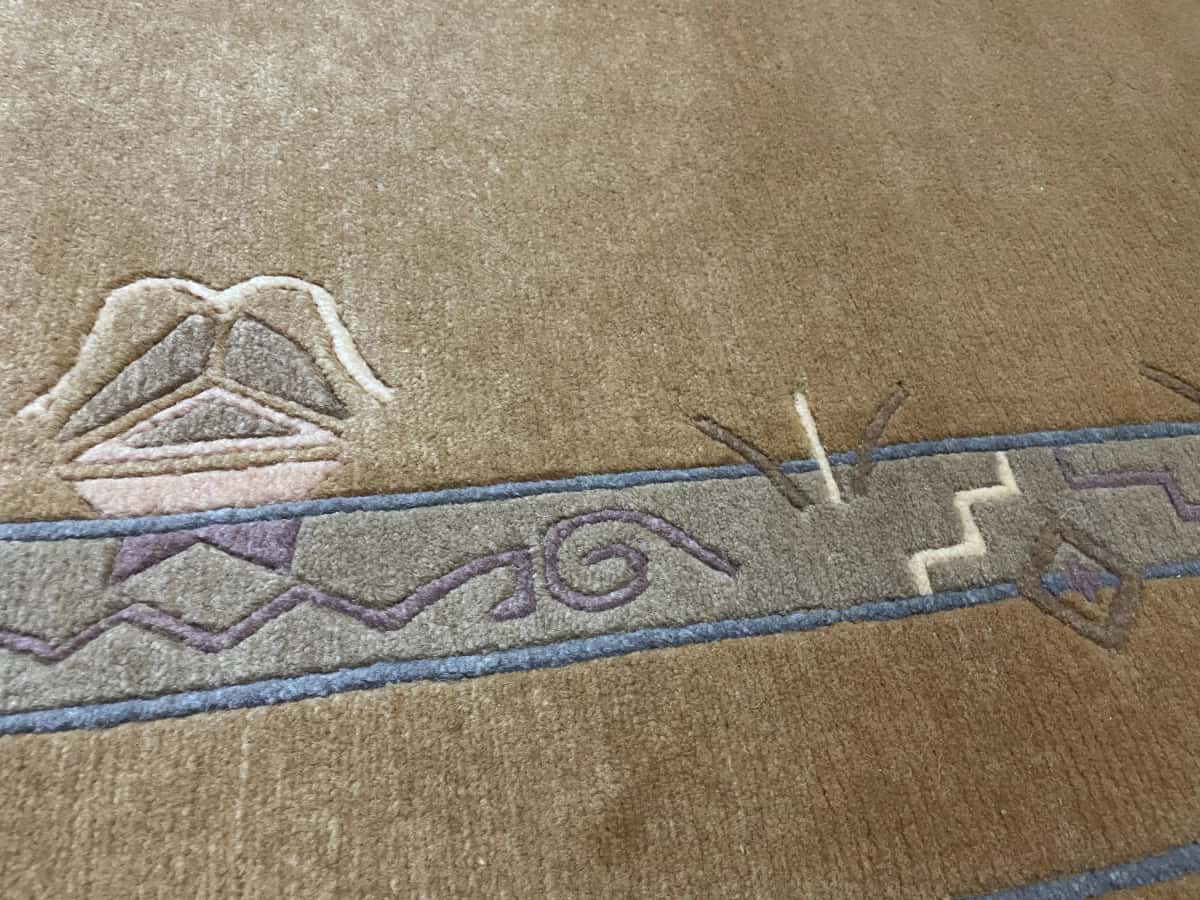Nepali rug of Tibetan style in dimensions 247 centimeters length by 200 centimeters width with mainly yellow colors — Texture close-up