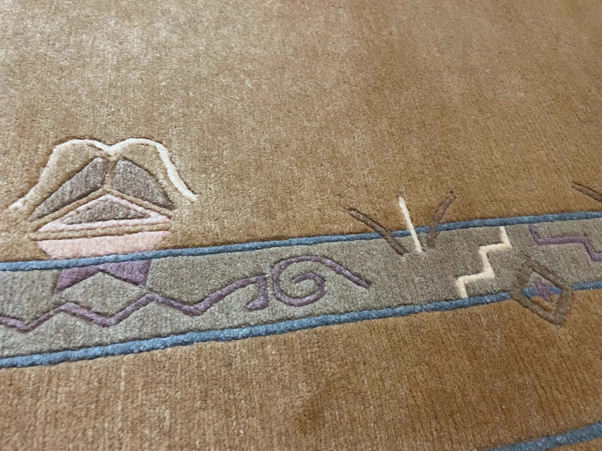 Nepali rug of Tibetan style in dimensions 247 centimeters length by 200 centimeters width with mainly yellow colors — Texture close-up