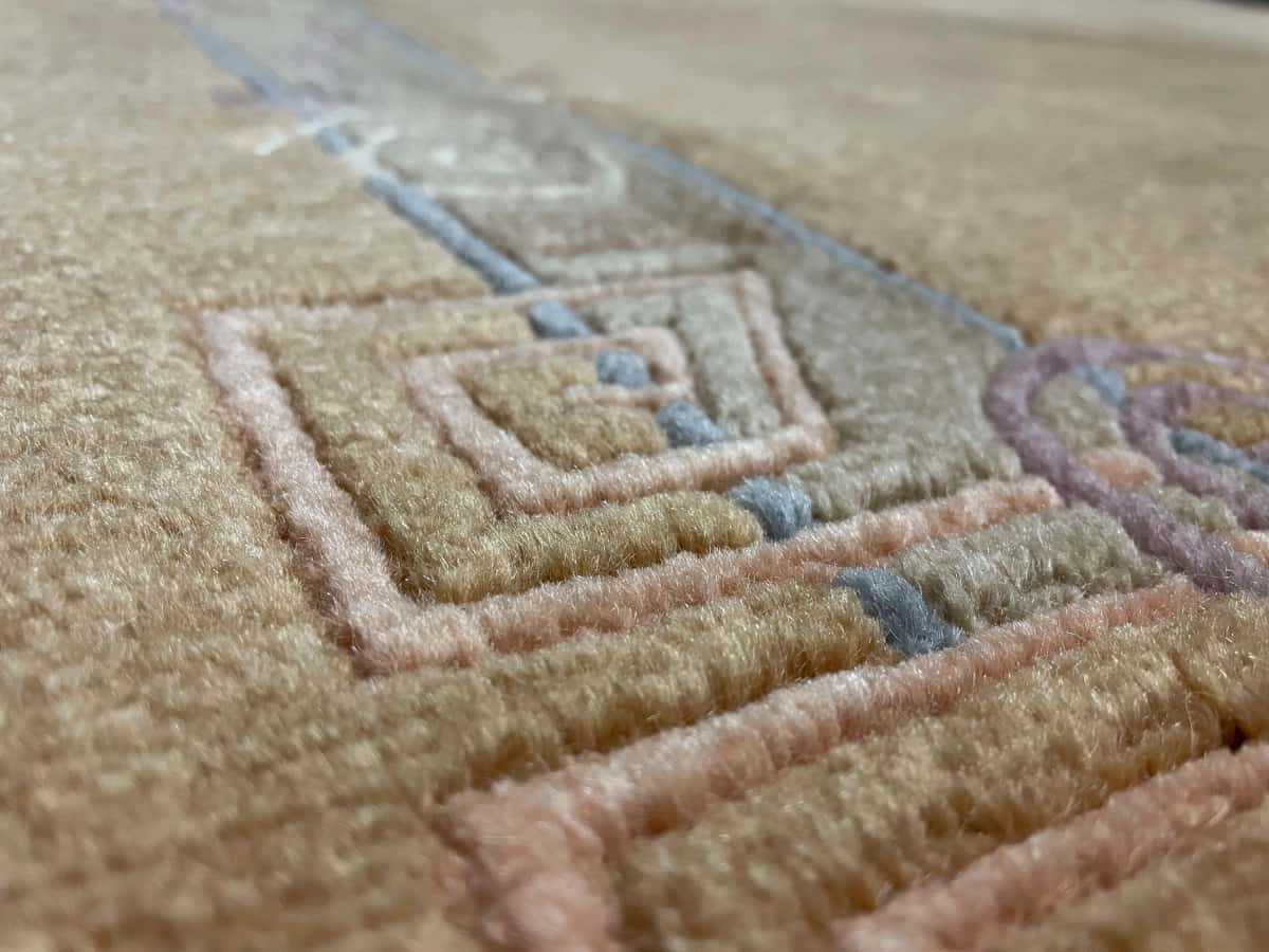 Nepali rug of Tibetan style in dimensions 247 centimeters length by 200 centimeters width with mainly yellow colors — Texture close-up
