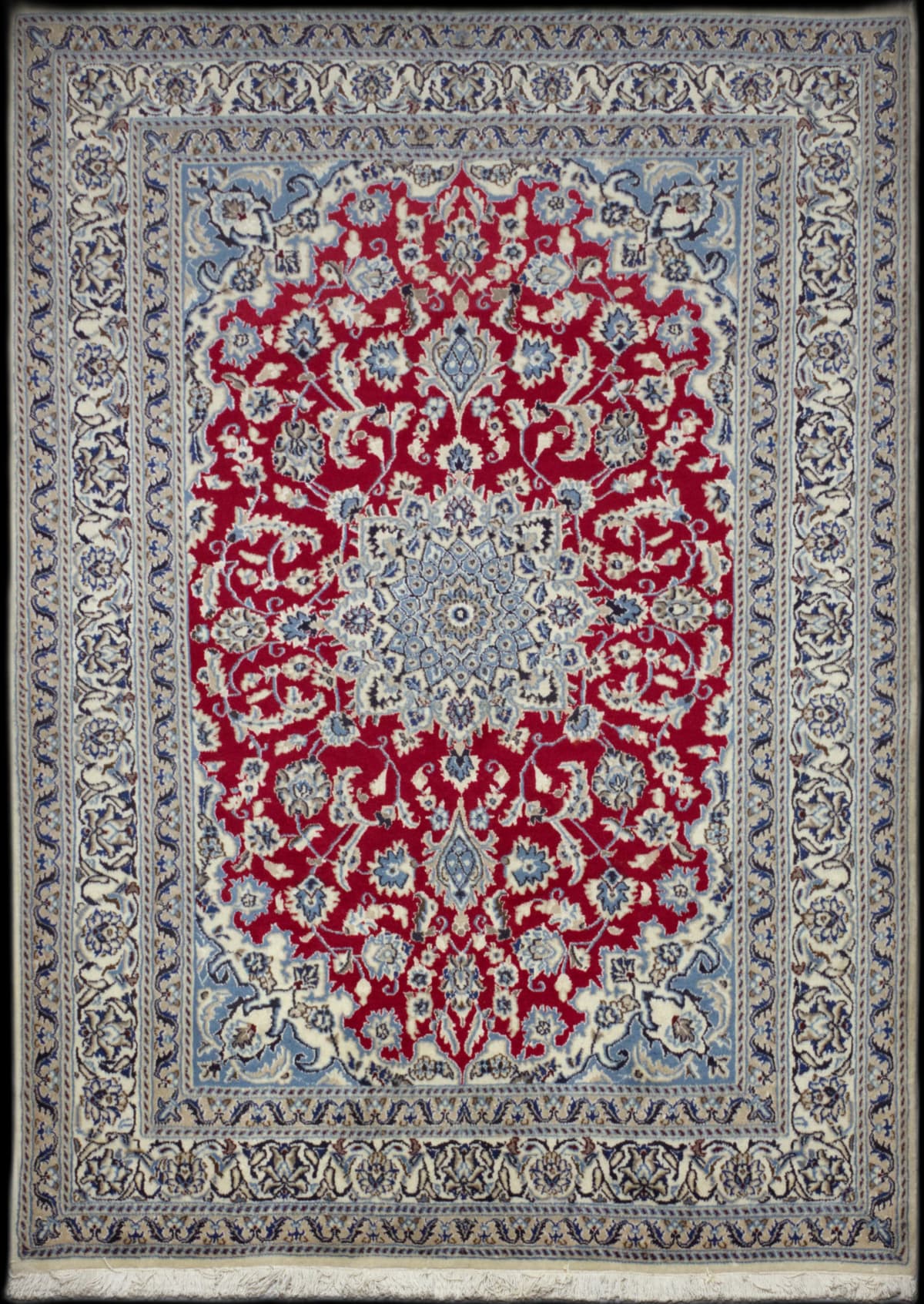 alfombra persa en dimensiones 242 centímetros de largo por 163 centímetros de ancho con colores principalmente rojo