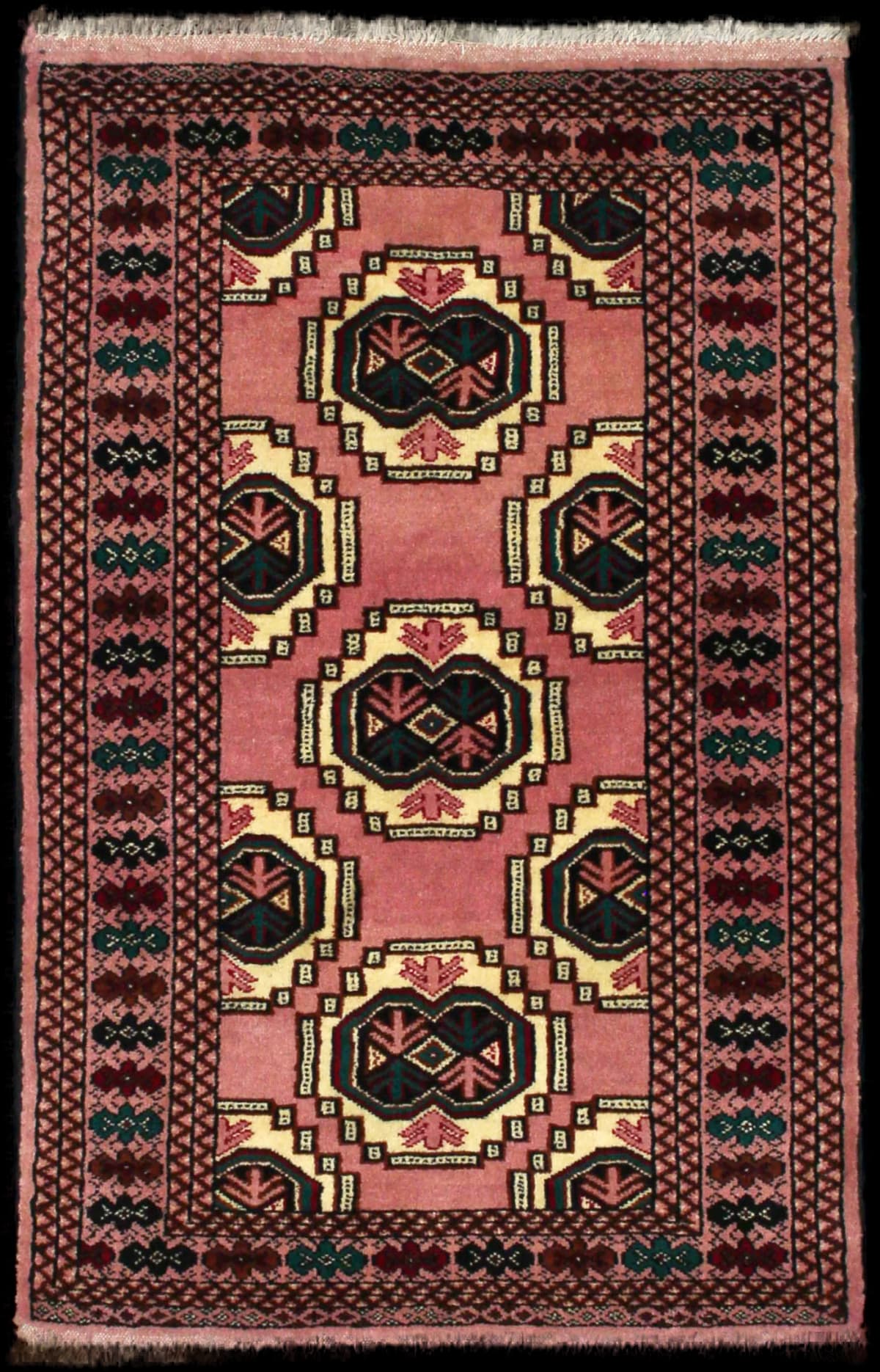 Persian rug of Turkoman style in dimensions 125 centimeters length by 85 centimeters width with mainly pink colors