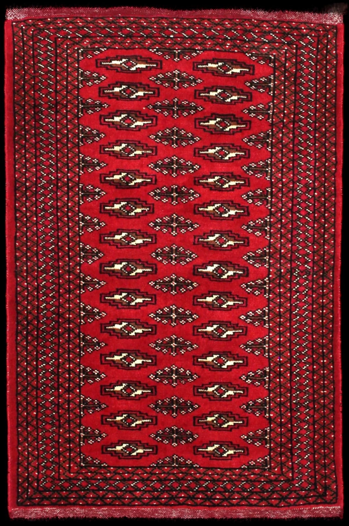 alfombra persa de estilo turcomana en dimensiones 122 centímetros de largo por 80 centímetros de ancho con colores principalmente rojo