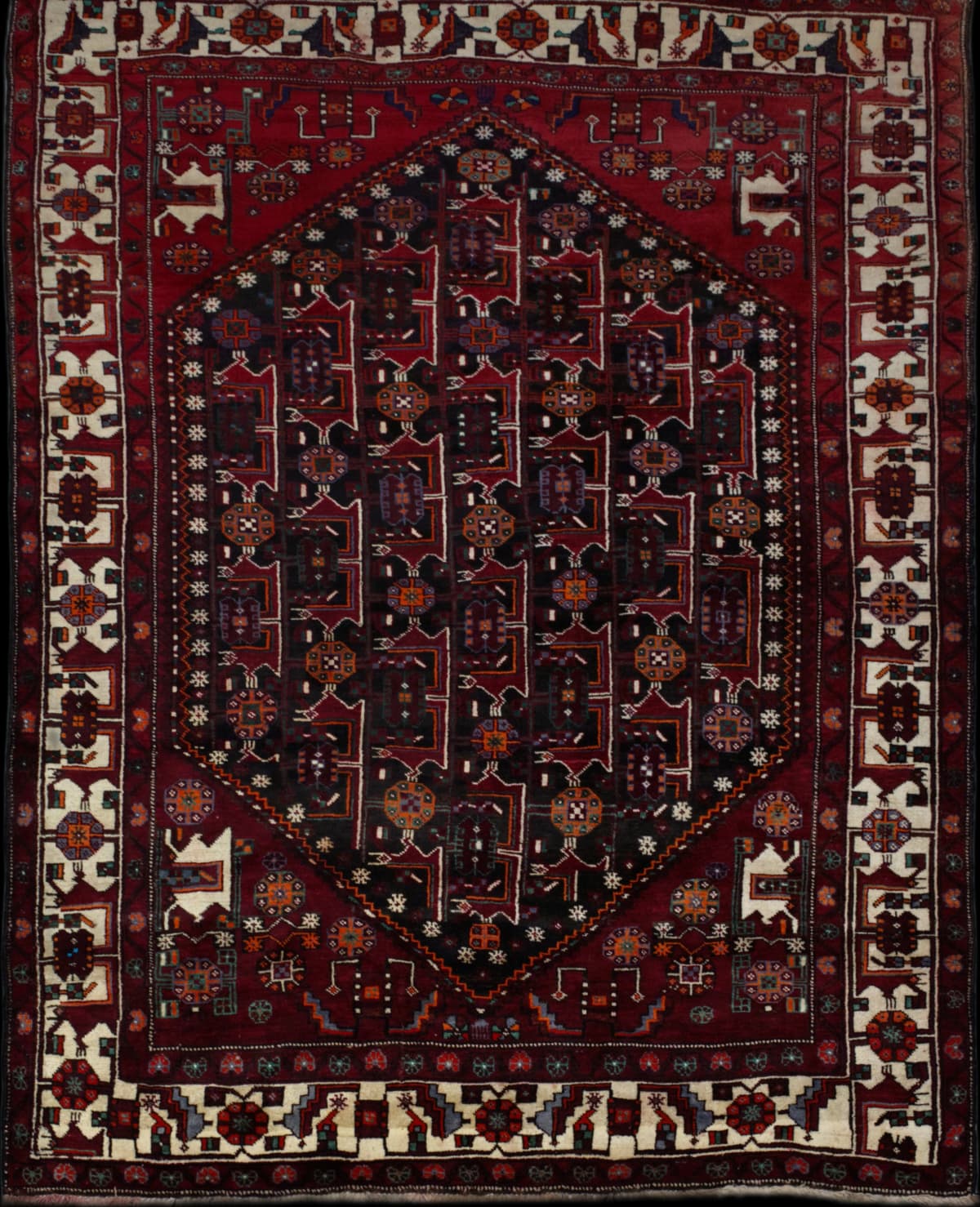 Persian rug in dimensions 294 centimeters length by 205 centimeters width with mainly red colors