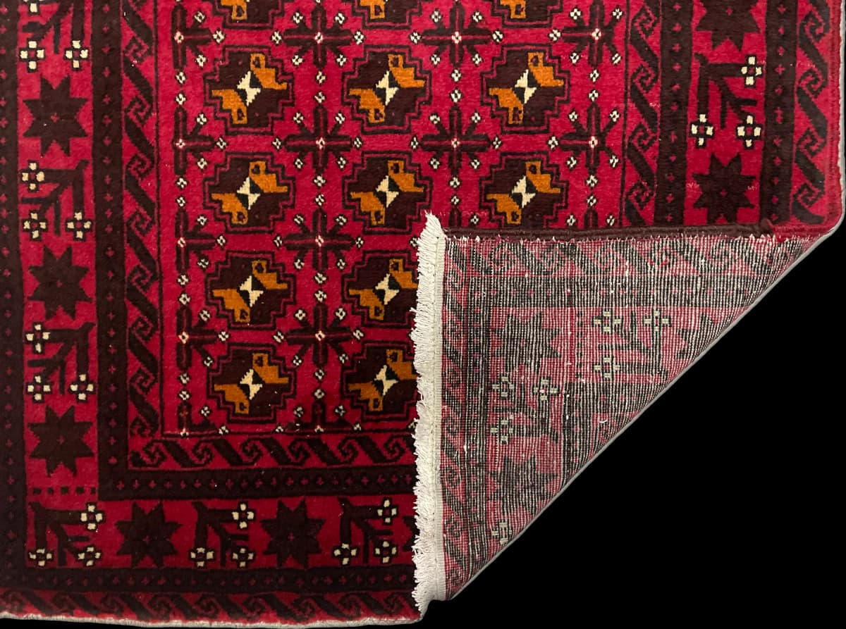 Perserteppich Belutsch, orientalisch, 100x200 cm, überwiegend in Rot — Gefaltet