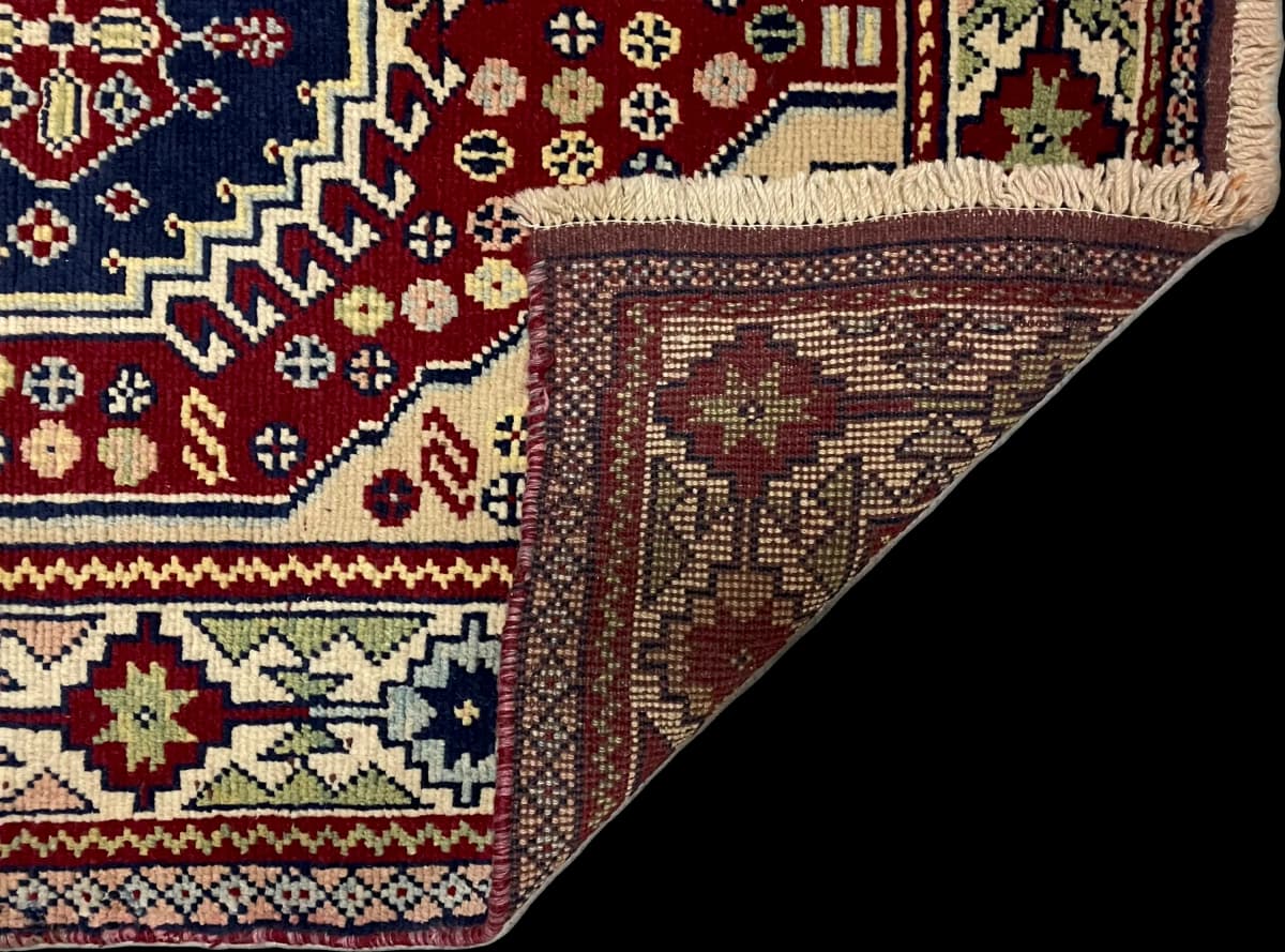 Perserteppich Belutsch, orientalisch, 103x145 cm, überwiegend in Beige und Rot — Gefaltet