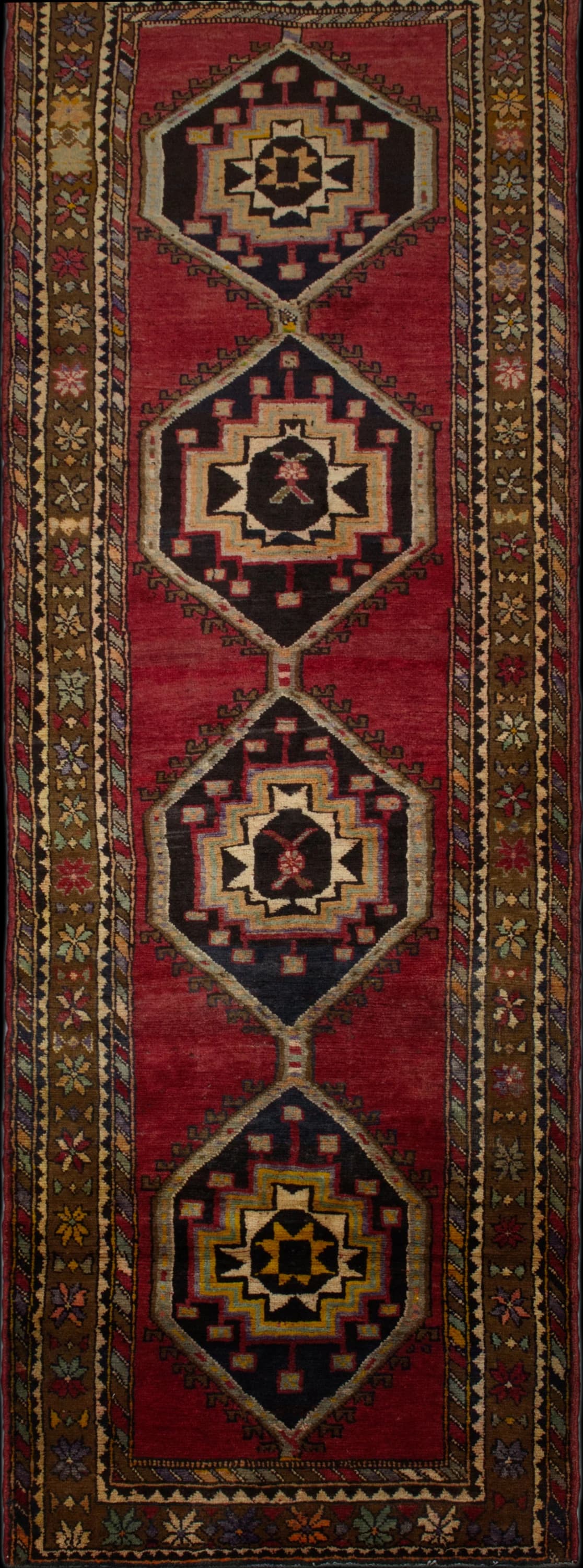 Persian rug in dimensions 373 centimeters length by 117 centimeters width with mainly red colors