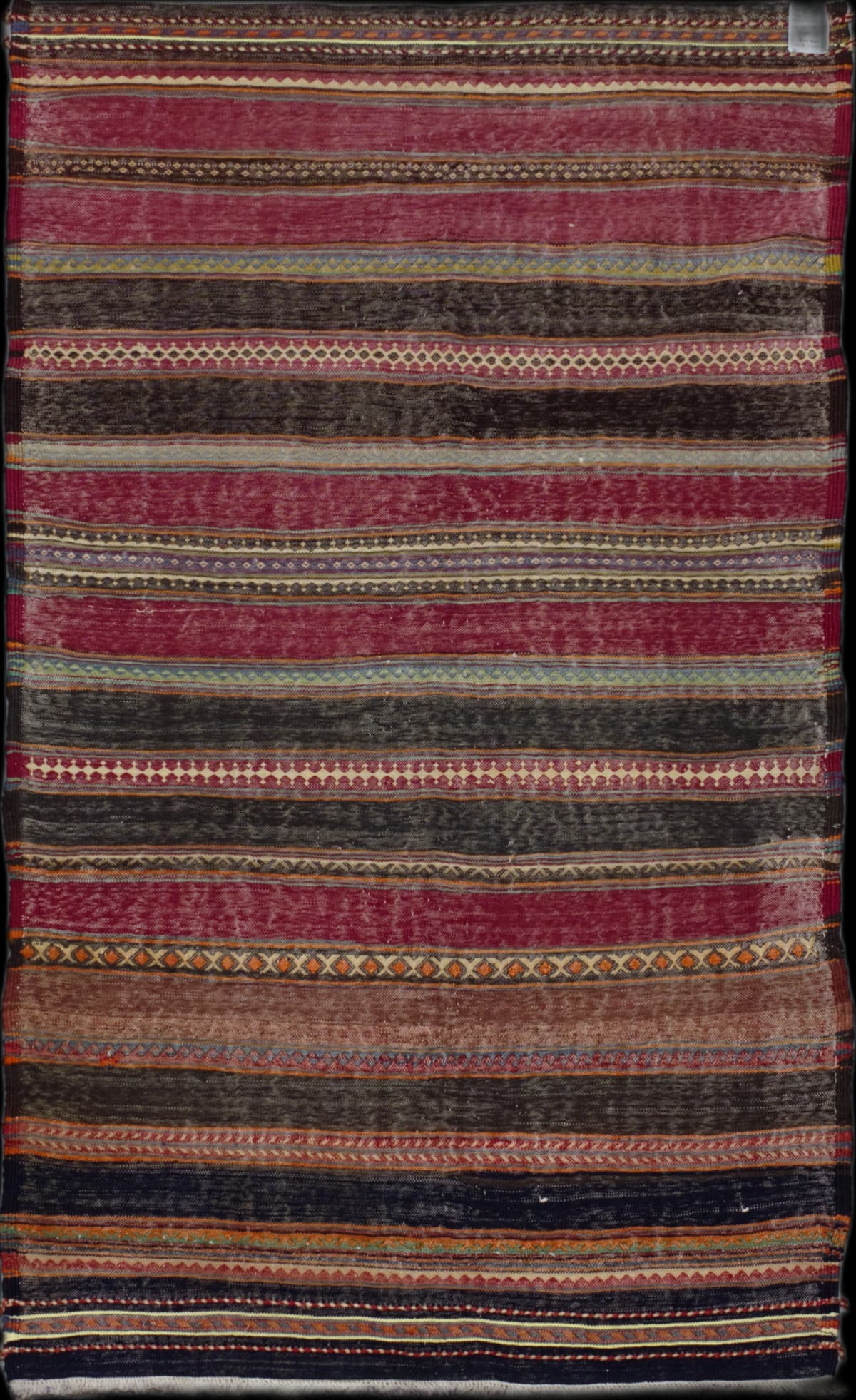 Persian rug in dimensions 213 centimeters length by 115 centimeters width with mainly red and black colors