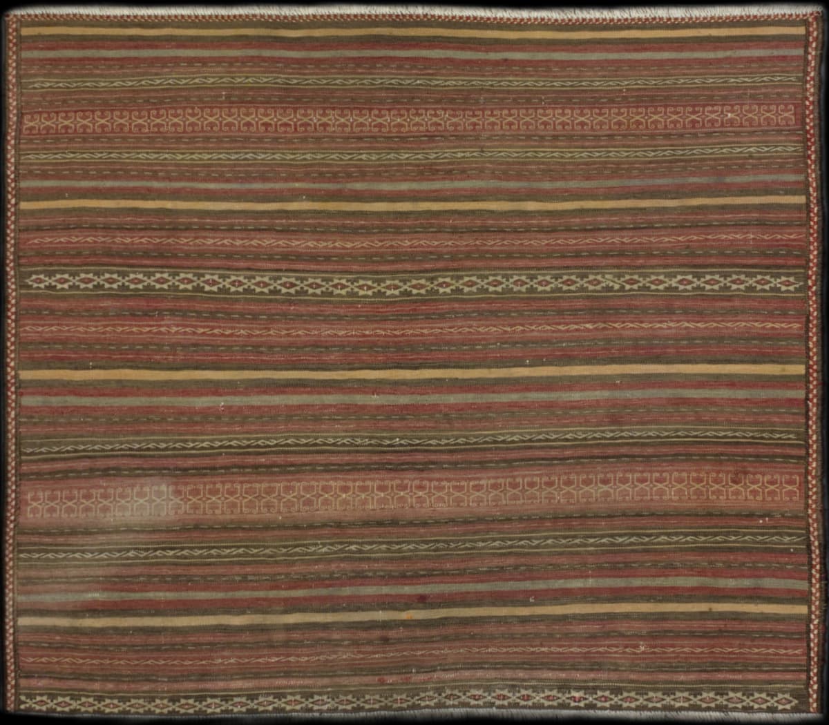 Persian rug of Sumak Kilim style in dimensions 144 centimeters length by 126 centimeters width with mainly red and brown colors