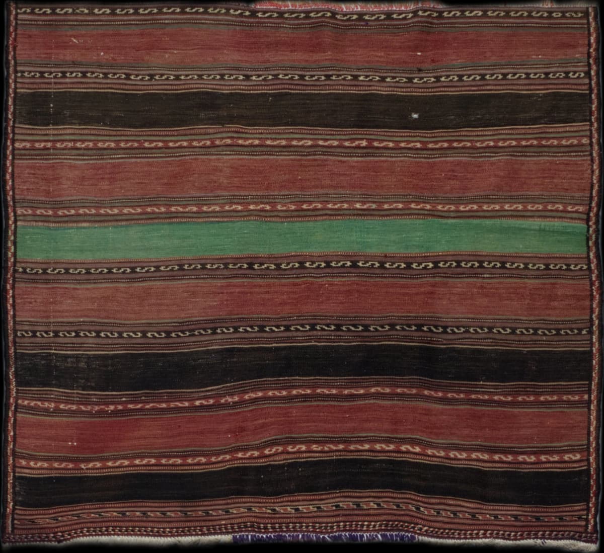 Persian rug of Sumak Kilim style in dimensions 142 centimeters length by 130 centimeters width with mainly red and brown colors
