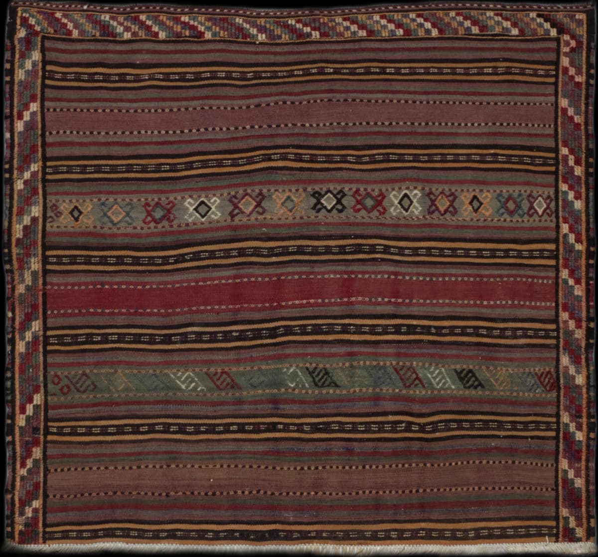 Persian rug of Sumak Kilim style in dimensions 142 centimeters length by 130 centimeters width with mainly red and brown colors