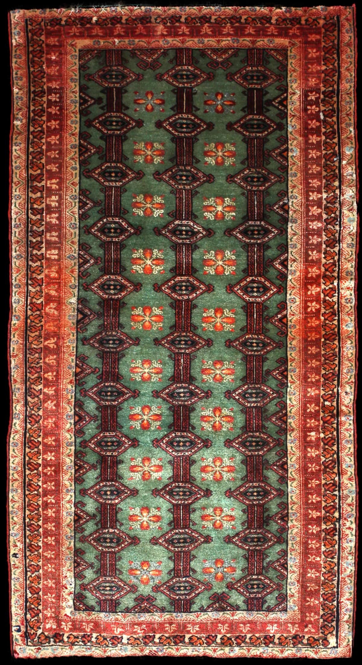 Persian rug of Turkoman style in dimensions 179 centimeters length by 94 centimeters width with mainly green and red colors