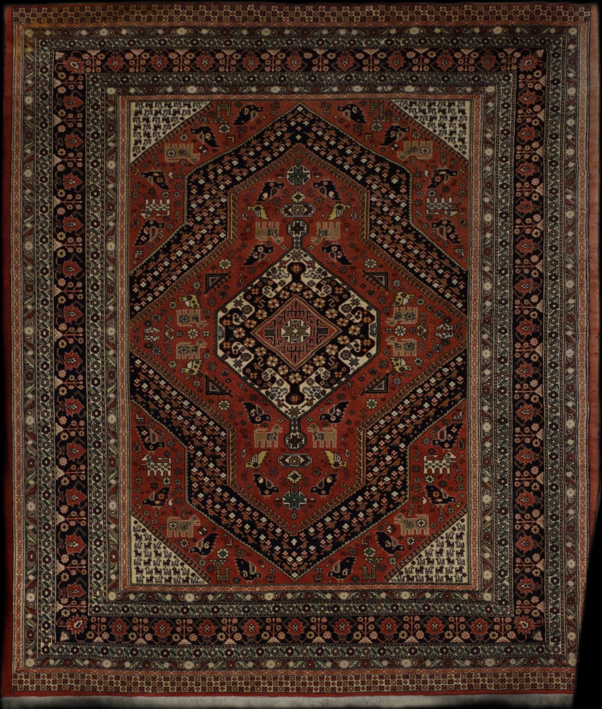 Persian rug in dimensions 285 centimeters length by 217 centimeters width with mainly red colors